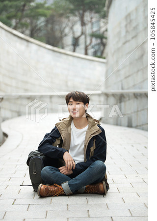 Young male college student traveling with a backpack in Korea Young male college student traveling with a backpack in Korea 105845425