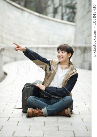 Young male college student traveling with a backpack in Korea 105845430