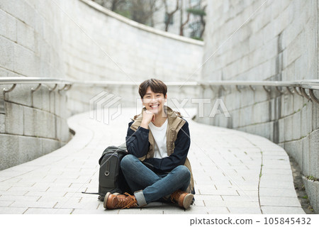 Young male college student traveling with a backpack in Korea Young male college student traveling with a backpack in Korea 105845432