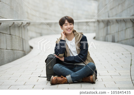 Young male college student traveling with a backpack in Korea Young male college student traveling with a backpack in Korea 105845435