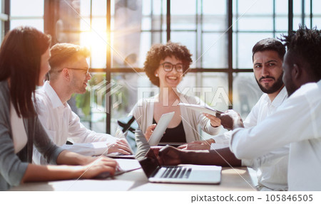 Employees working at computer together, discussing content Employees working at computer together, discussing content 105846505