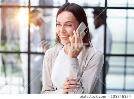 Businesswoman with phone in modern office 105846554