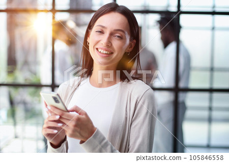 Businesswoman with phone in modern office 105846558