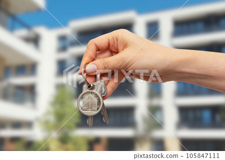 Real estate concept with home keys in hand Real estate concept with home keys in hand 105847111