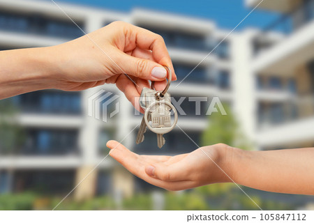 Real estate concept with home keys in hand 105847112