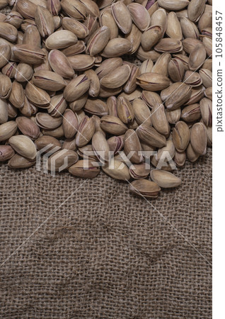 Pistachios on burlap sack. Healthy food high protein. Dietary nutrition. close-up Pistachios on burlap sack. Healthy food high protein. Dietary nutrition. close-up 105848457