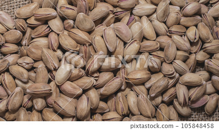 Pistachios on burlap sack. Healthy food high protein. Dietary nutrition. close-up Pistachios on burlap sack. Healthy food high protein. Dietary nutrition. close-up 105848458