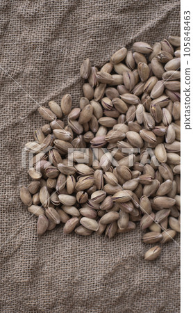 Pistachios on burlap sack. Healthy food high protein. Dietary nutrition. close-up Pistachios on burlap sack. Healthy food high protein. Dietary nutrition. close-up 105848463