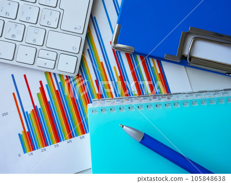 Graphs, binders, notebooks and keyboards on the table Graphs, binders, notebooks and keyboards on the table 105848638