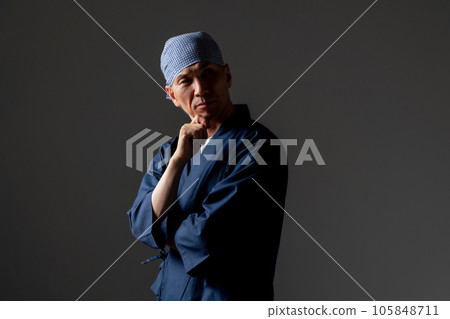 A man in a monk's work clothes thinks 105848711