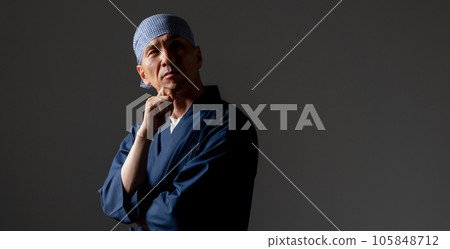 A man in a monk's work clothes thinks 105848712