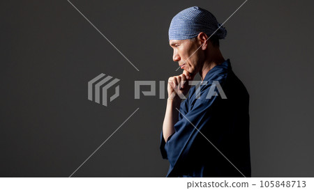 A man in a monk's work clothes thinks 105848713