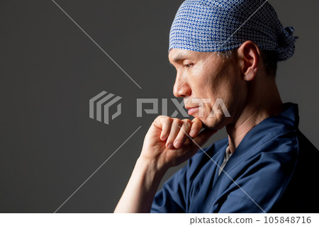 A man in a monk's work clothes thinks A man in a monk's work clothes thinks 105848716