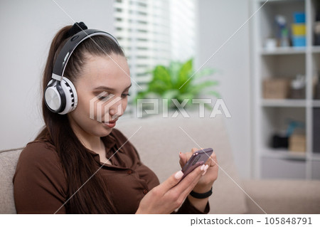 Close-up on the face of a girl wearing headphones on her head 105848791