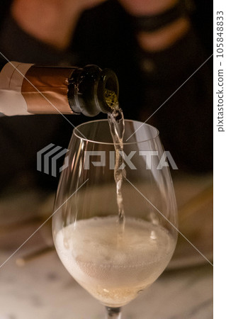 Man is pouring champagne in the glass Man is pouring champagne in the glass 105848833