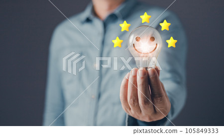 person hand holding power lightbulb and select on the five star to give satisfaction in service.rating very impressed.Customer service and Satisfaction concept. person hand holding power lightbulb and select on the five star to give satisfaction in service.rating very impressed.Customer service and Satisfaction concept. 105849333