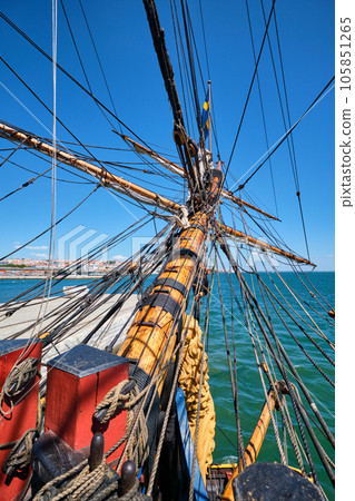 Bowspirit of old wooden sail ship with a lot of gear cordage rope 105851265