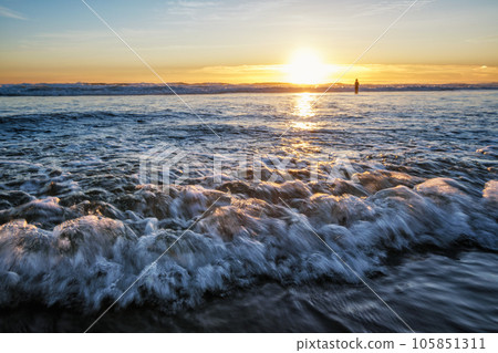 Atlantic ocean sunset with surging waves at Fonte da Telha beach, Costa da Caparica, Portugal Atlantic ocean sunset with surging waves at Fonte da Telha beach, Costa da Caparica, Portugal 105851311