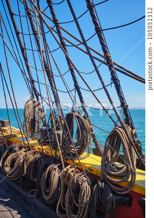 Old wooden Age of sail sailing ship ropes cordage and shroud 105851312