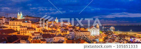 Panorama of Lisbon famous view from Miradouro de Santa Luzia tourist viewpoint over Alfama old city district at night. Lisbon, Portugal. Panorama of Lisbon famous view from Miradouro de Santa Luzia tourist viewpoint over Alfama old city district at night. Lisbon, Portugal. 105851333