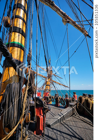 Deck with mast and ropes and bowspirit of wooden Age of sail sailing ship Deck with mast and ropes and bowspirit of wooden Age of sail sailing ship 105851336
