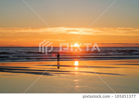 Atlantic ocean sunset with photographer silhouette taking images of surging waves at Fonte da Telha beach, Costa da Caparica, Portugal Atlantic ocean sunset with photographer silhouette taking images of surging waves at Fonte da Telha beach, Costa da Caparica, Portugal 105851377