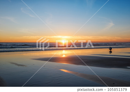 Atlantic ocean sunset with photographer silhouette taking images of surging waves at Fonte da Telha beach, Costa da Caparica, Portugal Atlantic ocean sunset with photographer silhouette taking images of surging waves at Fonte da Telha beach, Costa da Caparica, Portugal 105851379