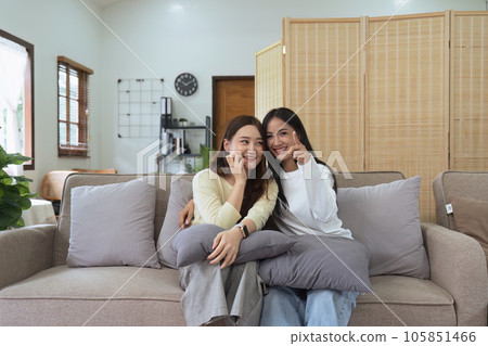 Asian lesbian woman couple enjoy watch TV together in house and feel happy watch movie on television. Homosexual-LGBTQ concept. 105851466
