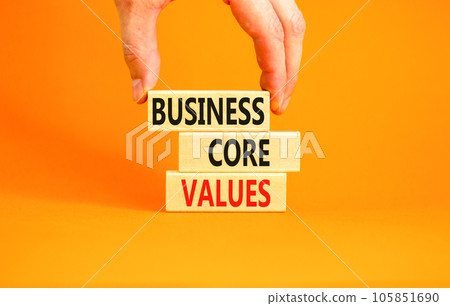 Business core values symbol. Concept words Business core values on wooden block. Beautiful orange background. Businessman hand. Business motivational business core values concept. Copy space. Business core values symbol. Concept words Business core values on wooden block. Beautiful orange background. Businessman hand. Business motivational business core values concept. Copy space. 105851690