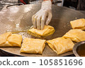 The process of making crepes crispy roti on a frying pan in a restaurant 105851696