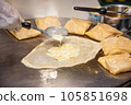 The process of making crepes crispy roti on a frying pan in a restaurant 105851698