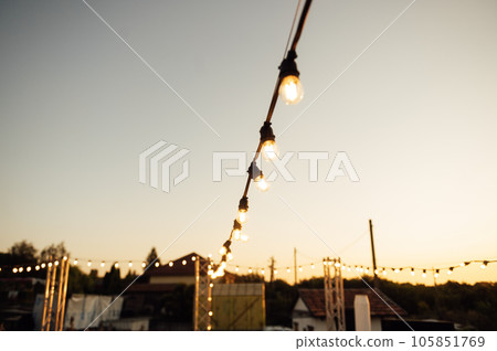 Decorative lighting lamps at a wedding party. Evening time Decorative lighting lamps at a wedding party. Evening time 105851769