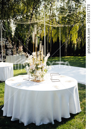 Wedding. Banquet. The chairs and round table for guests, served with cutlery. 105851778