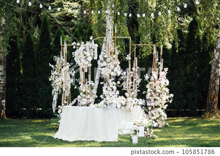 Wedding. Banquet. The chairs and round table for guests, served with cutlery. 105851786
