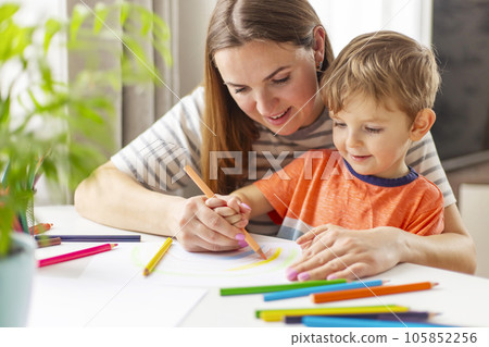 Mother and her son drawing together 105852256