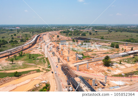 Aerial view of construction tractor car, bulldozer, or backhoe digging road or street in traffic transportation and agriculture concept. Engine working in urban city town. Aerial view of construction tractor car, bulldozer, or backhoe digging road or street in traffic transportation and agriculture concept. Engine working in urban city town. 105852364