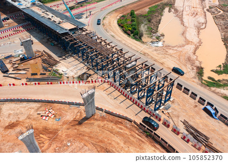 Aerial view of construction tractor car, bulldozer, or backhoe digging road or street in traffic transportation and agriculture concept. Engine working in urban city town. 105852370