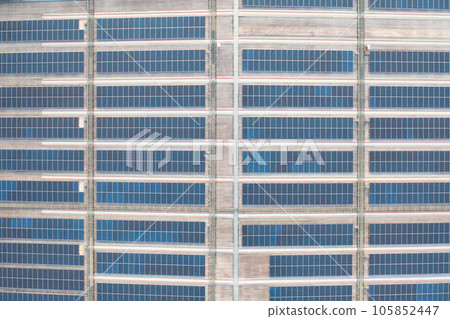 Aerial view of solar panels or solar cells on the roof of factory building rooftop. Power plant, renewable clean energy source. Eco technology for electric power in industry. 105852447
