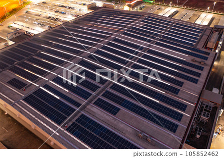 Aerial view of solar panels or solar cells on the roof of factory building rooftop. Power plant, renewable clean energy source. Eco technology for electric power in industry. 105852462