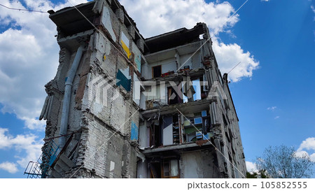 A multi-storey residential building destroyed by an air strike. A house without walls and windows A multi-storey residential building destroyed by an air strike. A house without walls and windows 105852555