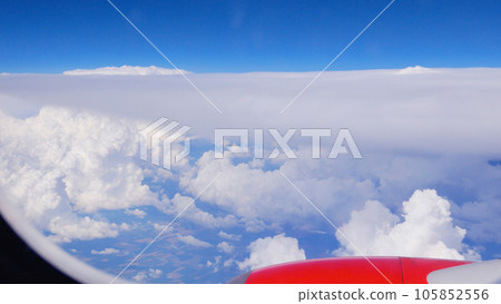View from the airplane window: snow-white cumulus clouds and blue sky 105852556