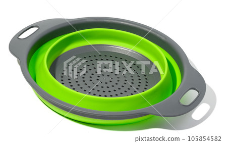 Plastic green collapsible colander on white isolated background Plastic green collapsible colander on white isolated background 105854582