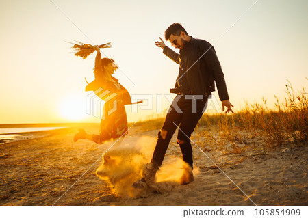 Enjoying time together. Stylish and loving couple enjoying each other by the sea. 105854909