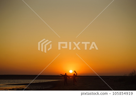 Enjoying time together. Stylish and loving couple enjoying each other by the sea. Enjoying time together. Stylish and loving couple enjoying each other by the sea. 105854919