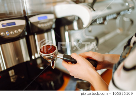 Female barista making coffee in a coffee machine. Conception of business and service. Takeaway food. 105855169