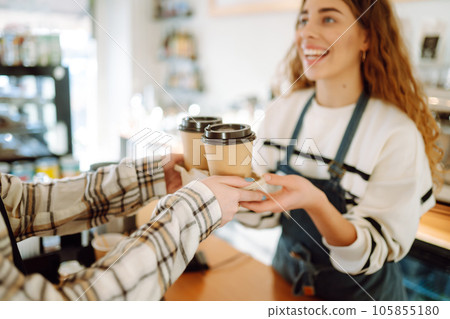 Barista woman at coffee shop holding take away coffee. Takeaway food. 105855180