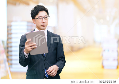 Tablet and businessman Tablet and businessman 105855316