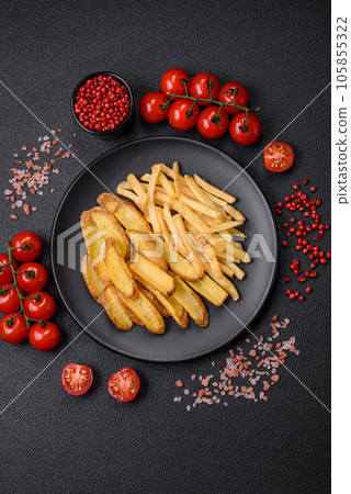 Delicious crispy french fries with salt and spices on a textured concrete background 105855322