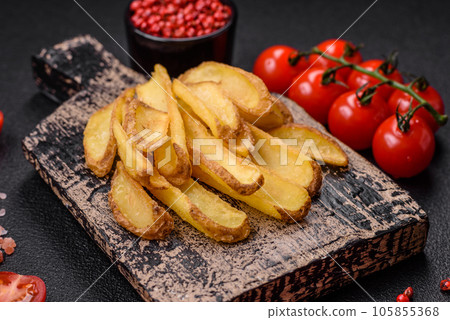 Delicious crispy potato deeps with salt and spices on a textured concrete background 105855368