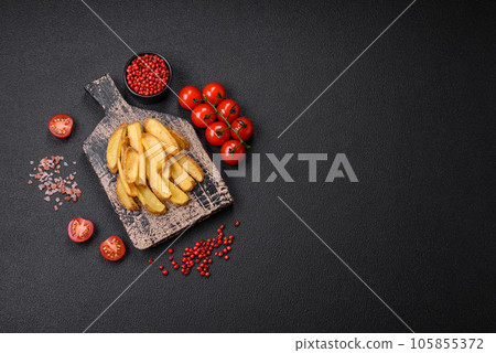 Delicious crispy potato deeps with salt and spices on a textured concrete background 105855372